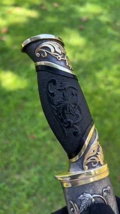 I present to you a handmade knife. Each element of the ornament and figures of birds are hand-cut out of metal, soldered to the scabbard and additionally decorated with engraving. Covered with silver and gold. The wooden handle of the knife is decorated w