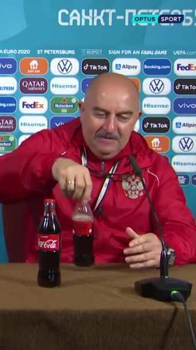 Russia's coach drinking Coca Cola on a press conference after Ronaldo removing the bottles on his press conference.