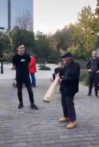 This Grandpa making it look easy while showing a young guy how to lift a board from the end with his hand