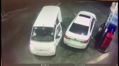 Trying to rob someone who's filling his car with gasoline.