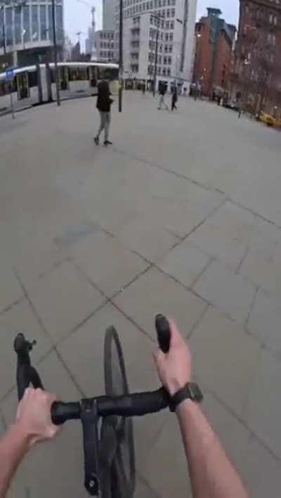 Biker snatches strangers phones and throws them on the ground.