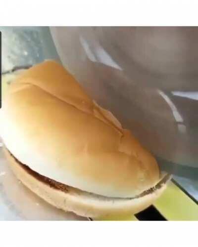 Cutting a hamburger in half with a miter saw.