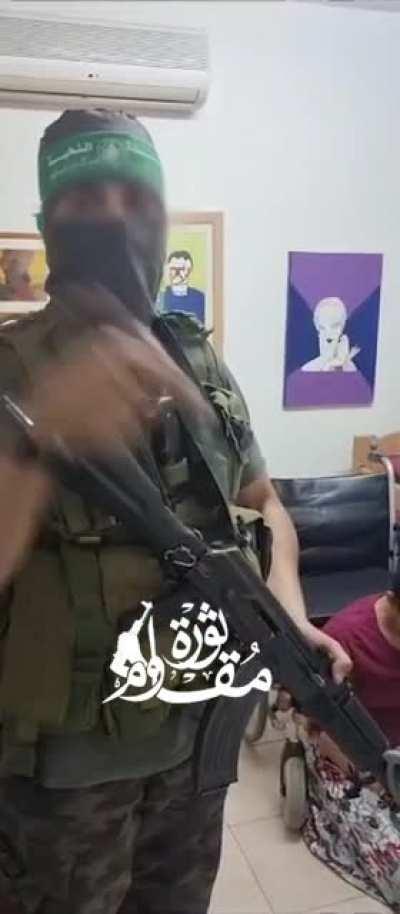 Terrorist capturing an elderly women and her caretaker. Hamas terrorists are very good at battling the unarmed