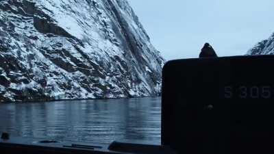 S305 Uredd surfaces in a narrow fjord as part of footage commemorating 111th anniversary of Norwegian submarine service