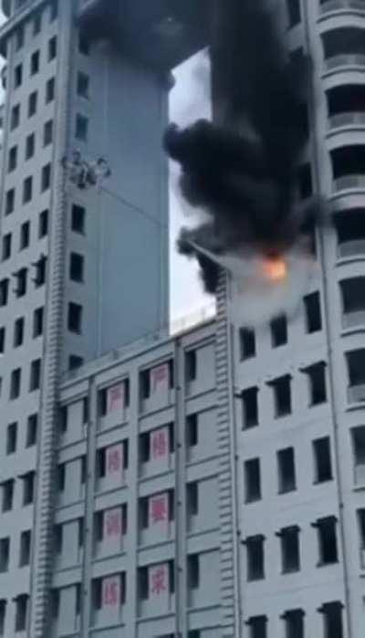 Drone putting out a blazing high-rise building fire.