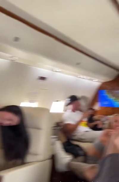 In front of friends on a private plane