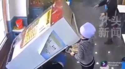 Waiter uses food tray to save mischievous little kid from being crushed by a refrigerator unit in restaurant