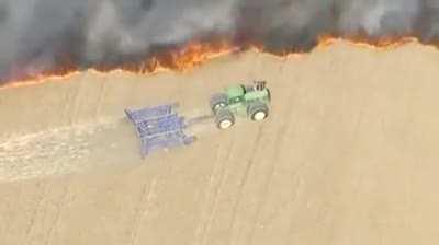 Farmer trying to save a field from wildfire in Denver.