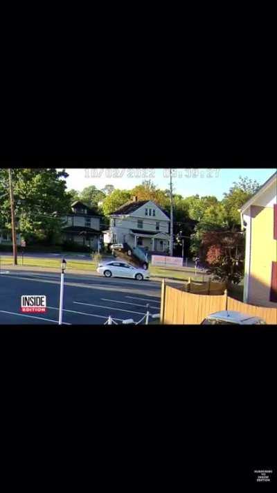 A car flew over a priest on his way to a church.