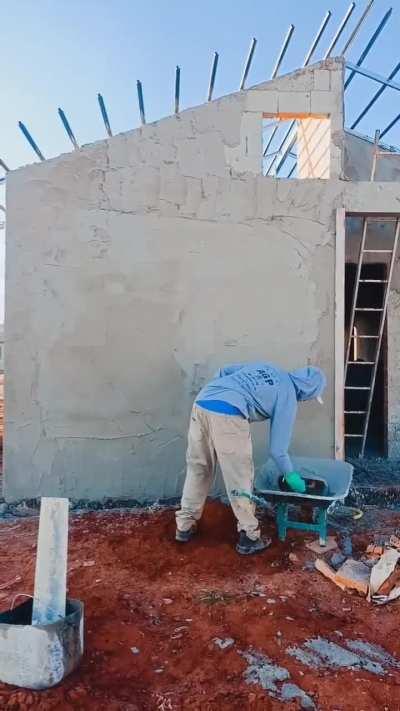 This guy throwing cement onto a wall.