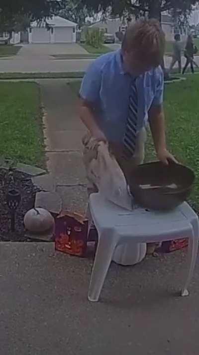 This kid saw the bowl was empty so he shared his candy with the next trick or treaters.