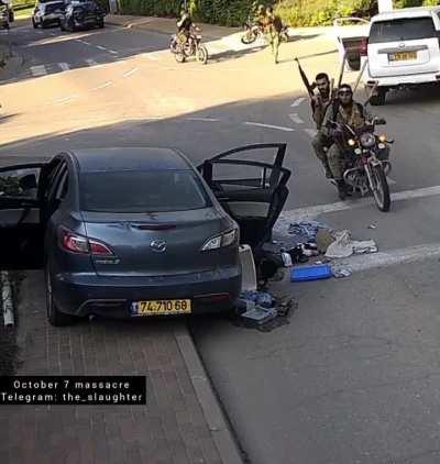 Hamas terrorists take Israelis that they killed out of the car and steal it