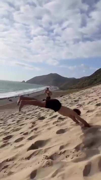 Man descending the hill with acrobatic movements