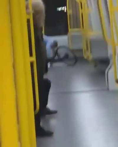 Guy riding bike on train smashes window