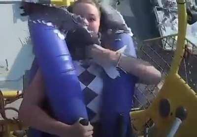 Girl gets hit by seagull on slingshot ride.