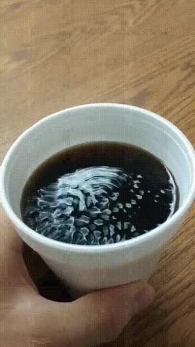 Sliding the coffee cup across produces the perfect vibrations to create patterns on the surface