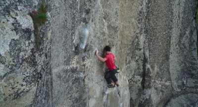 Alex Honnold climbing a V7 boulder problem ~1500 feet / ~500 meters above ground, after already climbing for two hours