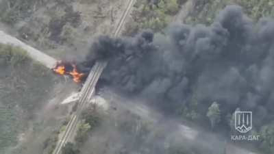 Ukrainian T-64BV rams a burning Russian MT-LB with infantry that was obstructing passage under the railway bridge near Selidove