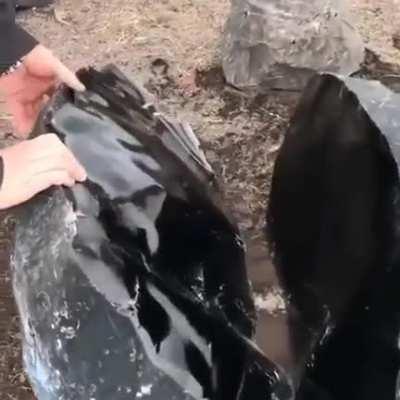 An enormous obsidian stone split in half