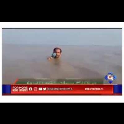 Pakistani journalist reporting floods....