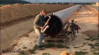 This guy playing the sax in front of a pipeline [Armin Küpper]