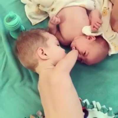 Handless kid assists his newborn sibling