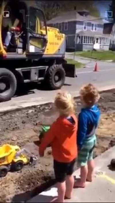 Construction worker pours soil in the kids construction toys to put a smile on their face