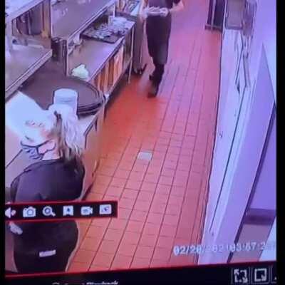 Woman sees that her coworker is about to pass out so she moves to catch him before his head hits the ground