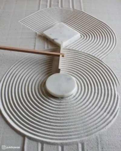 Raking zen garden sand