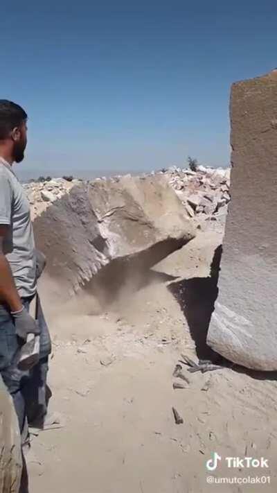 This guy splitting a giant rock very neatly