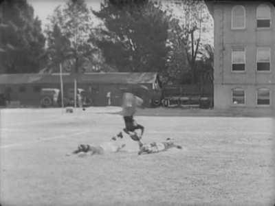 Buster Keaton eludes a tackle in Three Ages (1923)