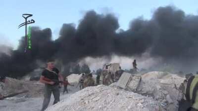 Opposition fighters celebrating the capture of al-Khazanat camp from the SAA are interrupted by incoming artillery fire - 5/25/2015