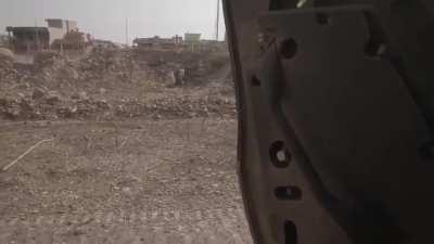 A Kurdish Peshmerga soldier takes fire from an ISIS machine gunner Mosul area, 2016.