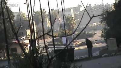 A FSA fighter pretends to sweep a Syrian street before grabbing a RPG and firing at a SAA BMP - 2013