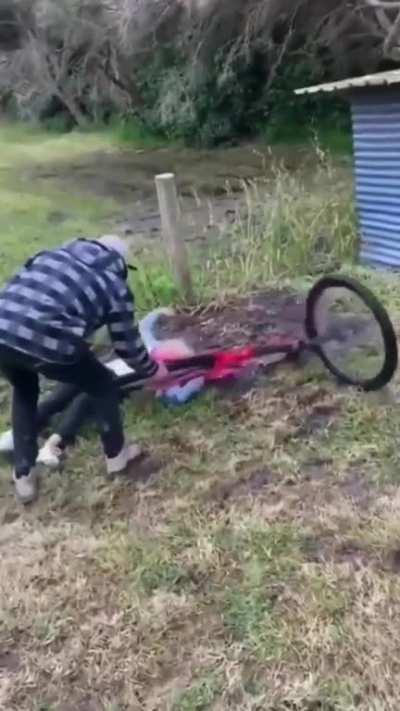 Attempting some sort of stunt involving a mountain bike and a shed