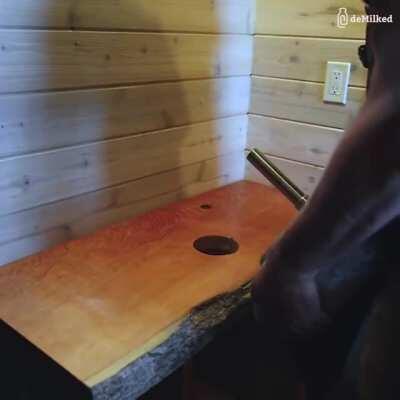 Bathroom sink made out of a rock.