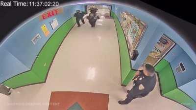 Uvalde hallway video shows heavily armed police in ballistic gear waiting around in the hallway while kids were getting shot.