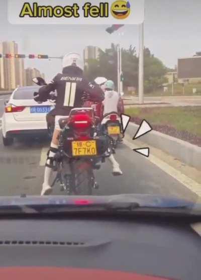 To reach the road with feet while riding a motorcycle