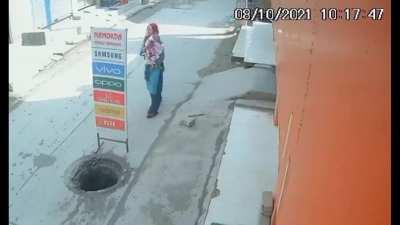 Mother With Baby Fall Into Sewer Hole