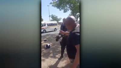 Two Johannesburg traffic cops suspended after 'assault video' surfaces of cop punching man, who claims the cops wanted money.