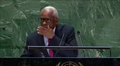 The President of haiti drinking a cup of water during his UN General Assembly speech