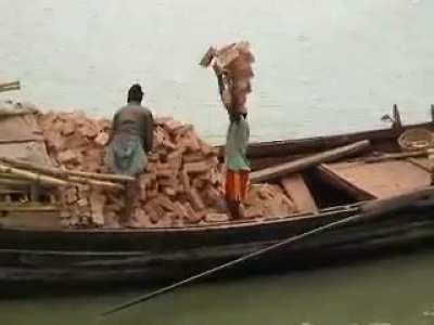 Man carrying 20 bricks on his head