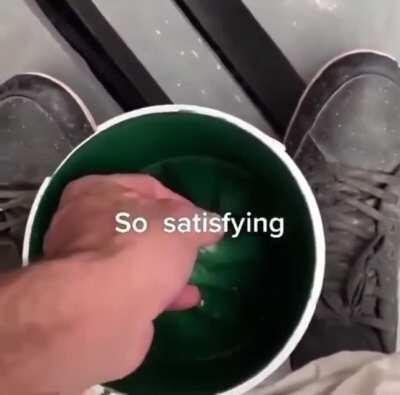 Pulling dried paint out of a bucket