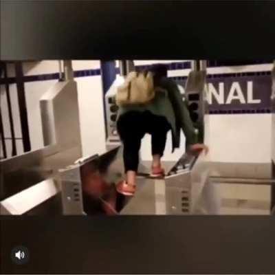 Attempting to jump over the turnstile.