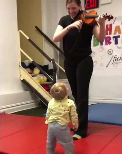 This little guy hearing a violin for the first time!