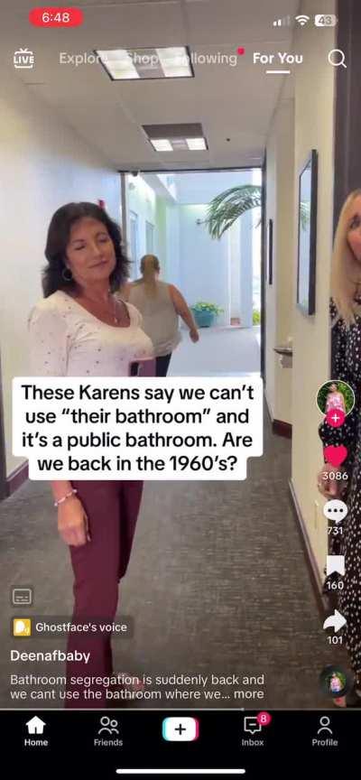 Women fighting over bathroom use inside office building