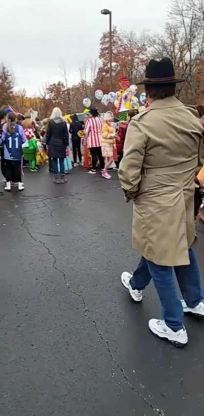 Guy shows off his 3rd leg in front of trick or treaters.