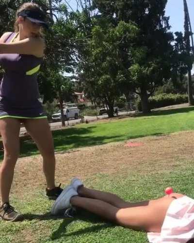 to hit the golf ball on her bestie's butt.