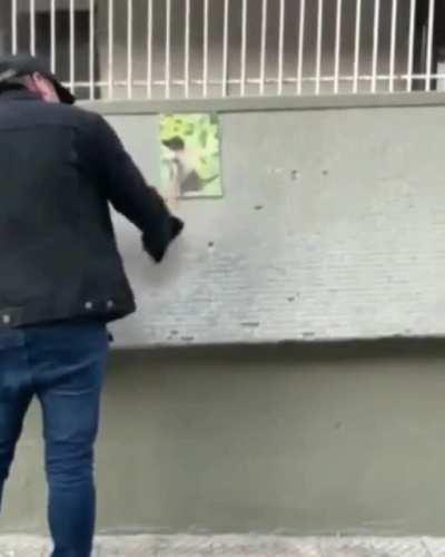 A spaniard migrant, Roberto Belmar, is very well known in Chile for his violent acts against left wing protesters. Here, is outside of a subway station destroying a piece of art showing the simbol of the October Rebellion (negro matapacos) and threatening