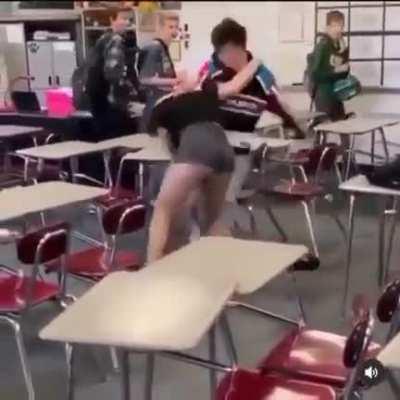 Teenage boy and girl fight in classroom